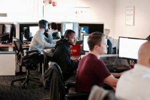 people in a room looking at their monitors